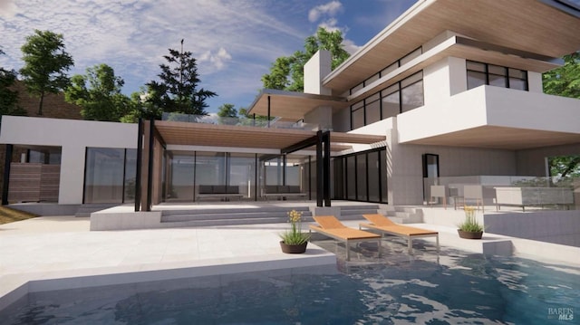 rear view of house featuring stucco siding and a patio