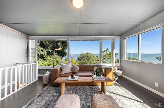 sunroom featuring a water view