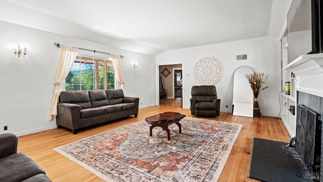 living room with wood-type flooring and lofted ceiling