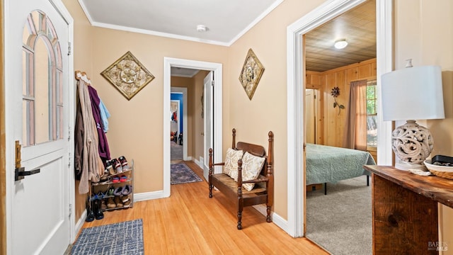 entrance foyer with wooden ceiling, crown molding, wood walls, and light hardwood / wood-style flooring