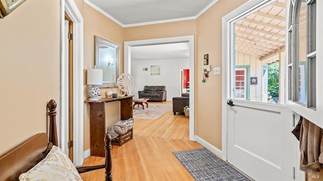 doorway to outside featuring hardwood / wood-style flooring and ornamental molding