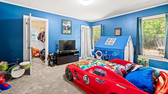 bedroom with multiple windows, light colored carpet, and a closet