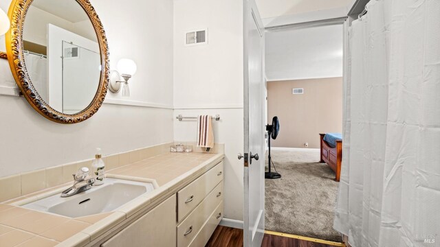 bathroom featuring vanity and hardwood / wood-style flooring