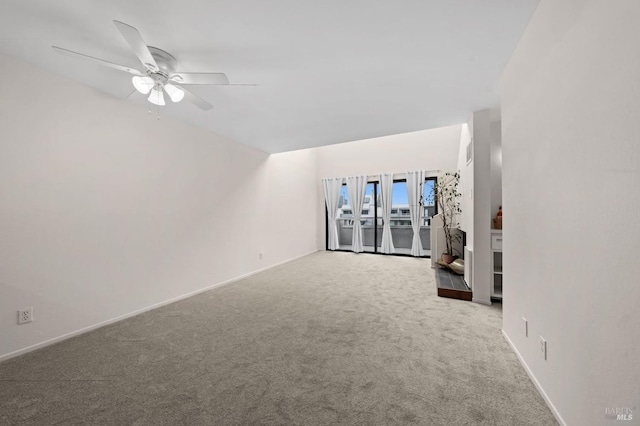 carpeted empty room featuring ceiling fan