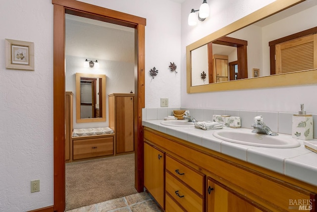 bathroom featuring tile patterned flooring and vanity