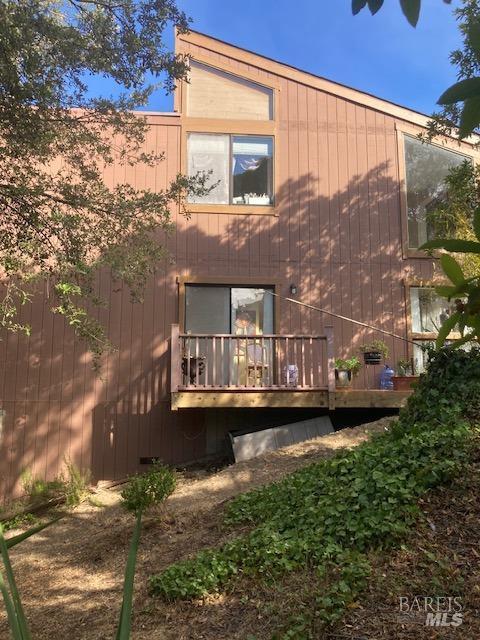 back of house featuring a deck