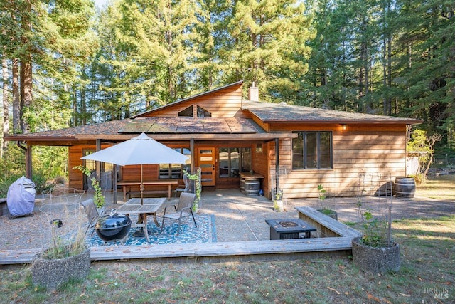 view of patio / terrace featuring french doors, an outdoor fire pit, and a deck