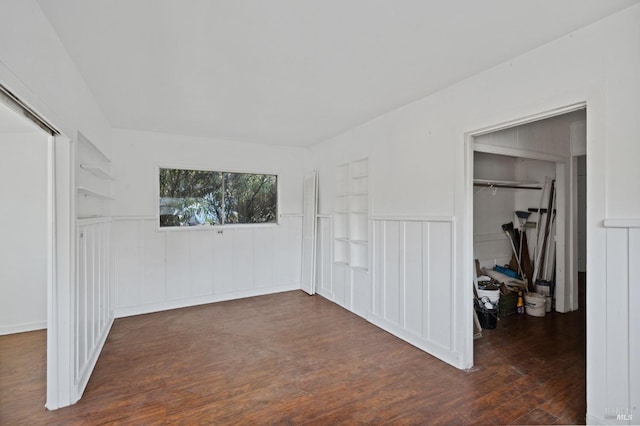 unfurnished bedroom featuring a closet and dark hardwood / wood-style flooring