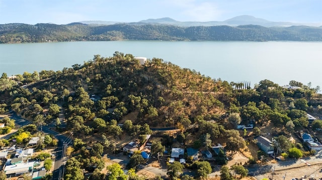 drone / aerial view featuring a water and mountain view