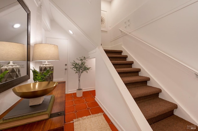 staircase featuring tile patterned flooring