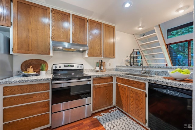 kitchen with black dishwasher, electric range, dark wood-type flooring, sink, and light stone countertops