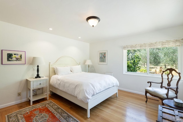 bedroom with recessed lighting, light wood-type flooring, and baseboards