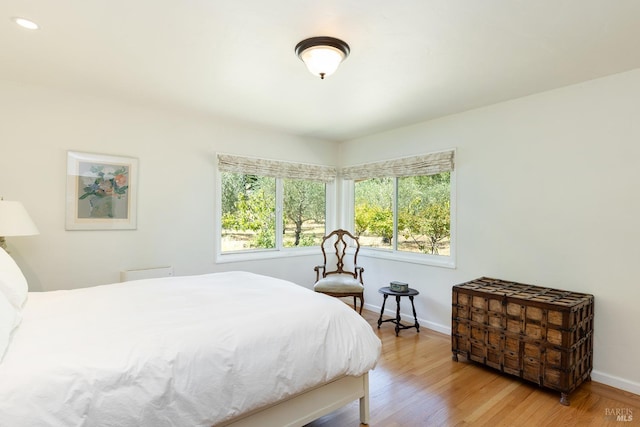 bedroom featuring baseboards and wood finished floors