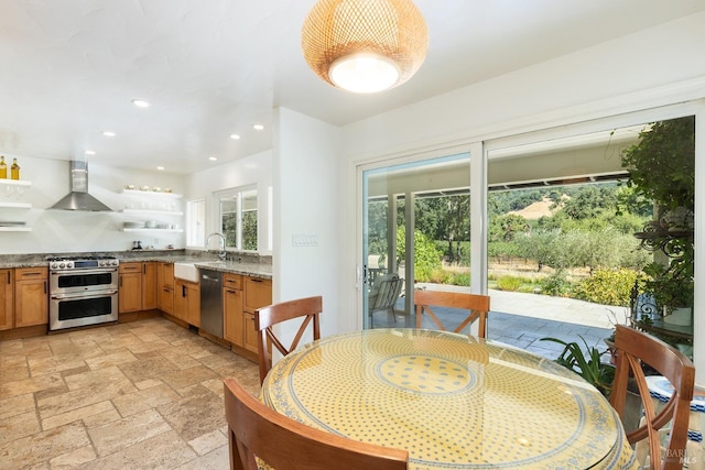 dining space featuring a healthy amount of sunlight, stone tile flooring, and recessed lighting