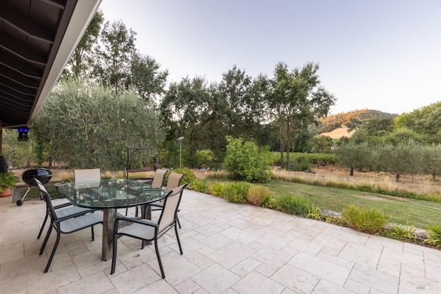 view of patio featuring a mountain view and outdoor dining area