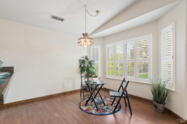 dining area with wood finished floors, visible vents, and baseboards