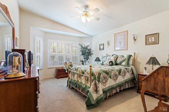 bedroom featuring ceiling fan, light carpet, and vaulted ceiling