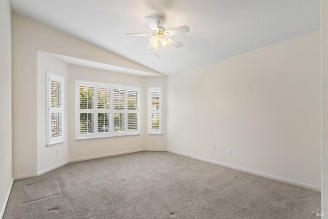 bedroom with ceiling fan, vaulted ceiling, and light colored carpet