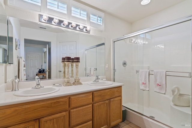 bathroom featuring vanity, tile patterned flooring, and an enclosed shower