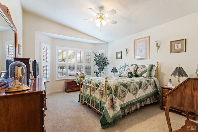 bedroom featuring a ceiling fan, lofted ceiling, and carpet