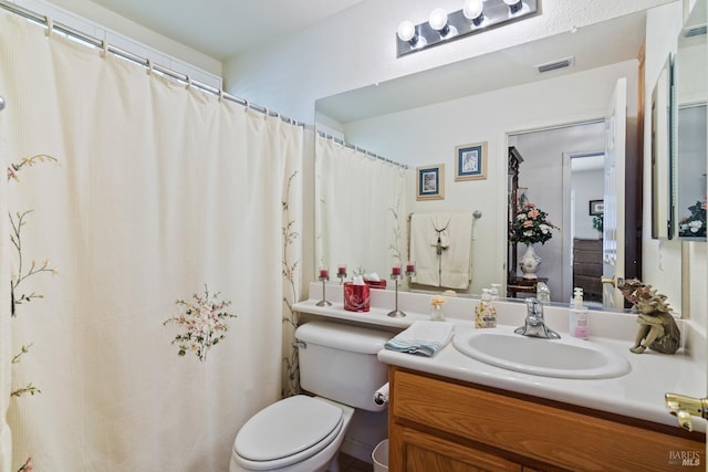 full bathroom featuring visible vents, vanity, and toilet