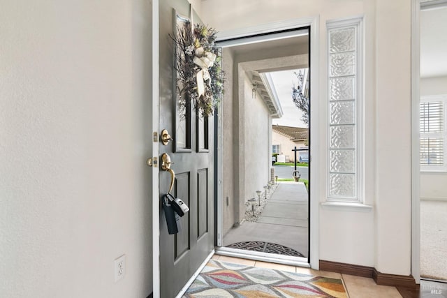 entryway featuring baseboards