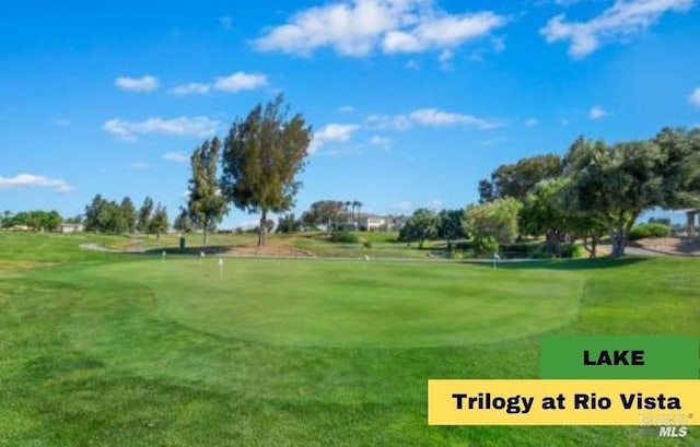 surrounding community with golf course view and a lawn