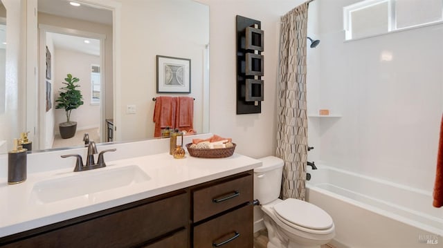 full bathroom with shower / bath combo, vanity, and toilet