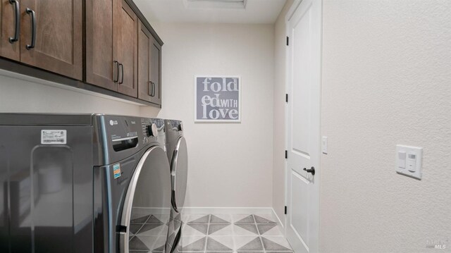 clothes washing area featuring light tile patterned floors, cabinets, and independent washer and dryer