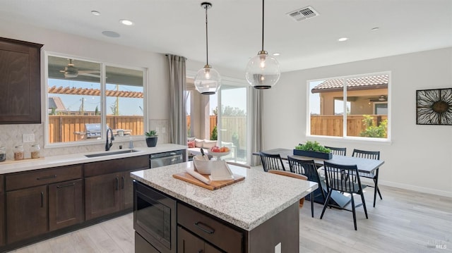 kitchen featuring decorative backsplash, a healthy amount of sunlight, sink, and appliances with stainless steel finishes