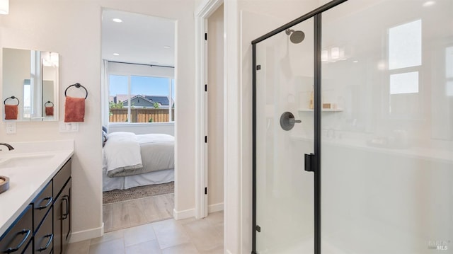 bathroom featuring tile patterned floors, vanity, and walk in shower