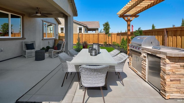 view of patio with an outdoor kitchen, grilling area, a pergola, and ceiling fan