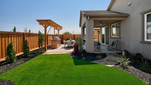 view of yard with ceiling fan and a patio