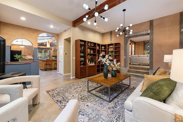 living room featuring a high ceiling, concrete flooring, and a chandelier