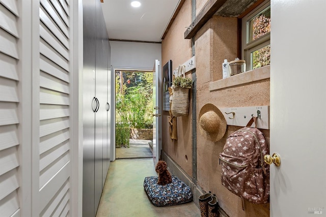 doorway to outside with plenty of natural light and crown molding