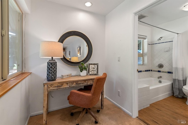 home office with light hardwood / wood-style flooring