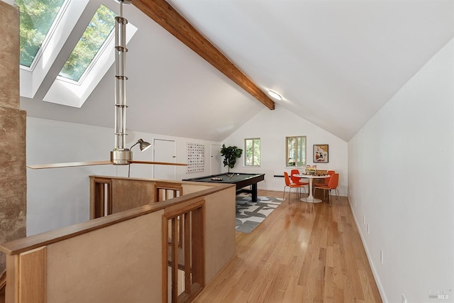 additional living space with vaulted ceiling with skylight, pool table, and light hardwood / wood-style floors