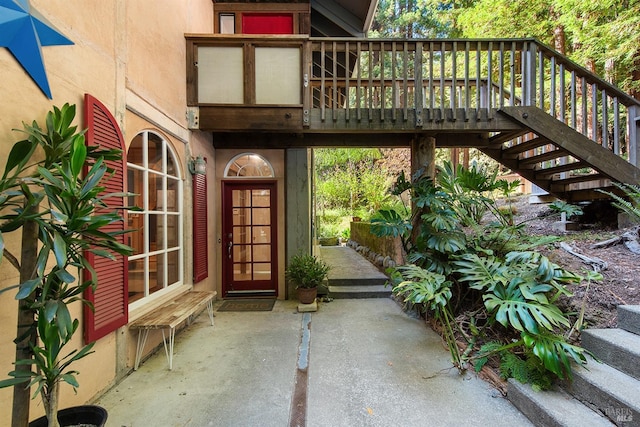 doorway to property with a deck and a patio area