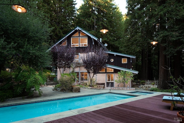 view of swimming pool with a wooden deck