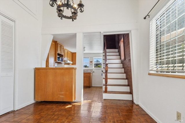 interior space with an inviting chandelier and dark parquet flooring