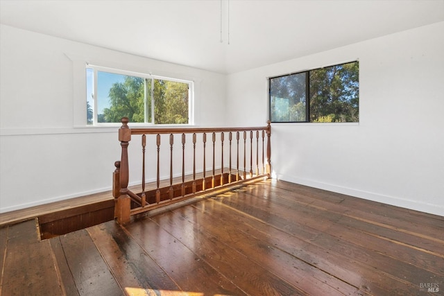 unfurnished room with dark wood-type flooring