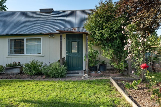 property entrance with a lawn