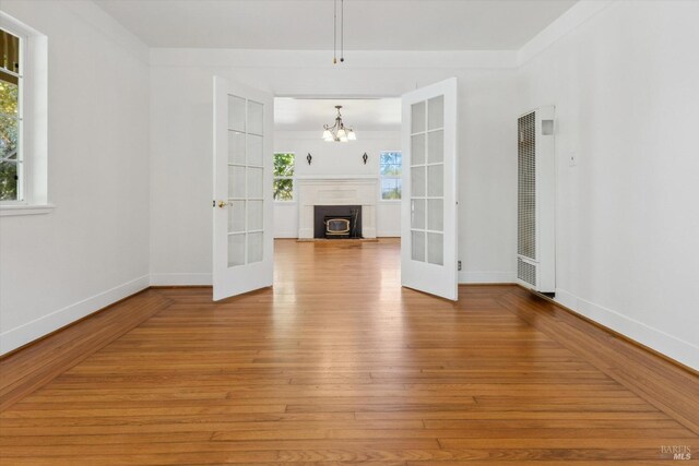 4344 Langner Ave, Santa Rosa, CA 95407 - unfurnished living room with a heating unit, plenty of natural light, french doors, and wood-type flooring