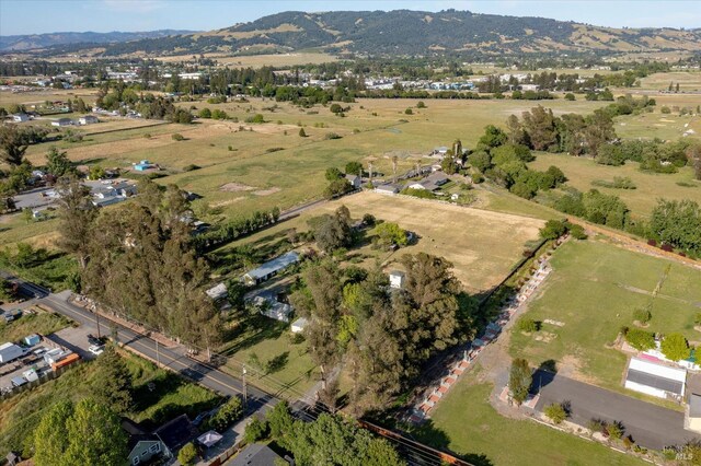 drone / aerial view featuring a rural view and a mountain view