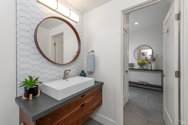 bathroom with vanity and decorative backsplash