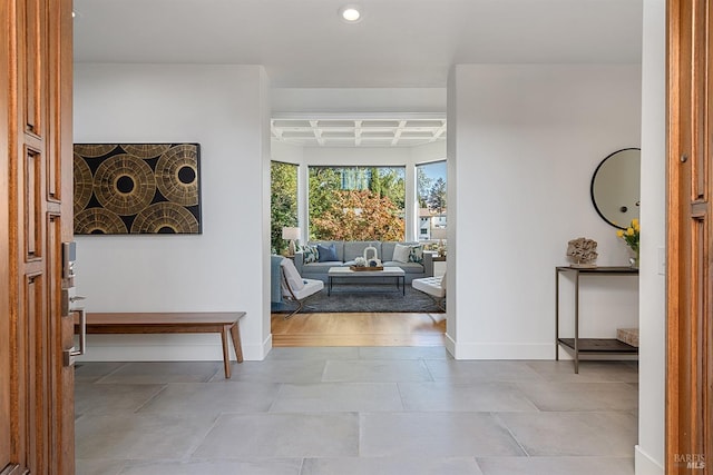 entryway featuring beamed ceiling and coffered ceiling