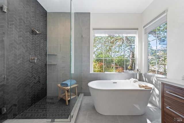 bathroom with tile patterned flooring and separate shower and tub