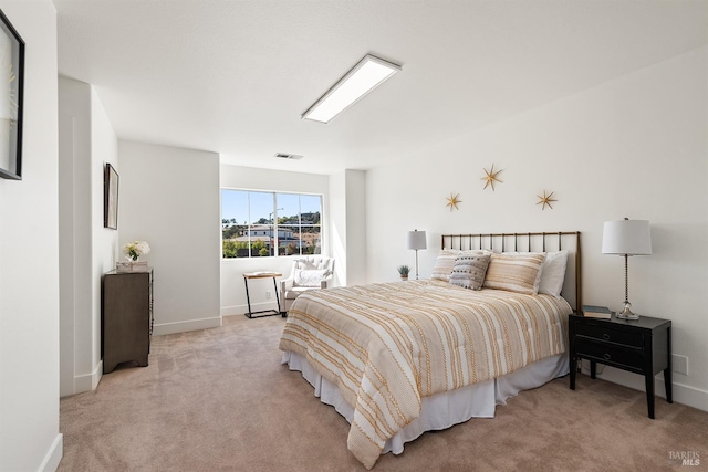 bedroom featuring light carpet