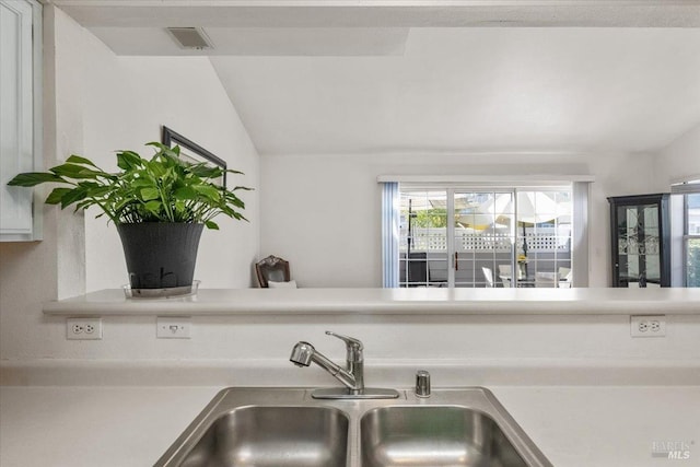 kitchen with lofted ceiling and sink