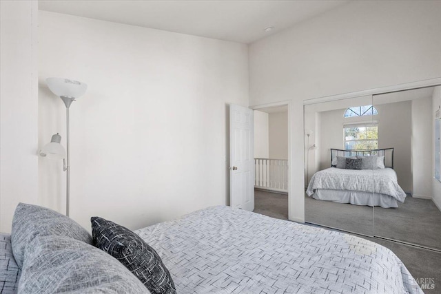 bedroom featuring carpet and a towering ceiling